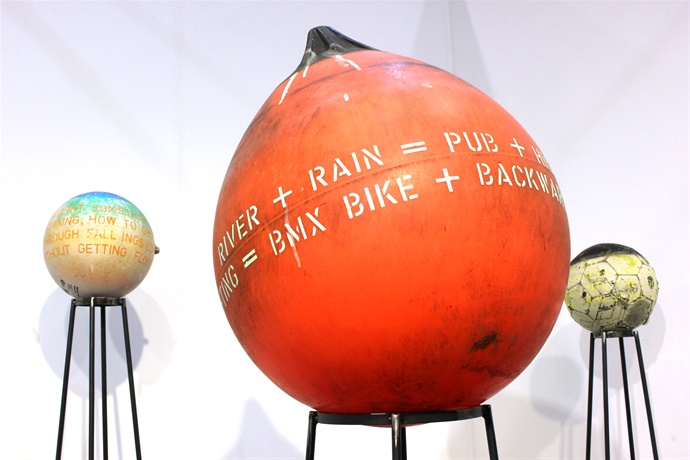 Buoys on metal stands in exhibition by Yoke