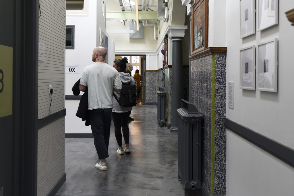 Two people exploring the former Wakefield Carnegie Library at an Open Studios event, now home to The Art House Artist Studios.