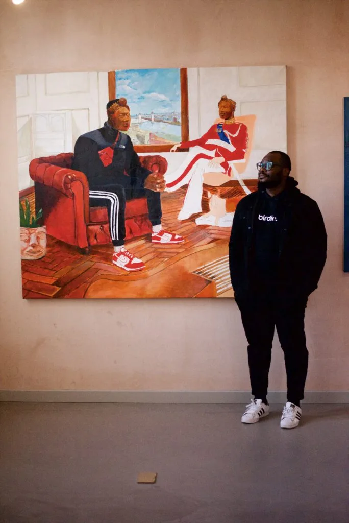 Tonye Ekine stood next to one of his large scale paintings.