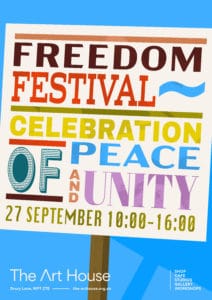 Freedom Festival poster reading: Freedom Festival – Celebration of Peace and Unity, 27 September 10:00–16:00, in bold colourful lettering on a sign against a blue background