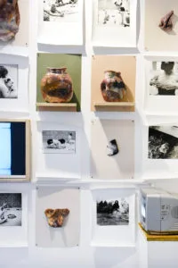 Wall display of images and ceramics in Emily Ryalls: Divine Archives
