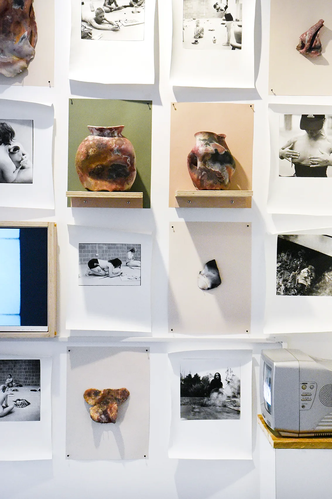 Wall display of images and ceramics in Emily Ryalls: Divine Archives