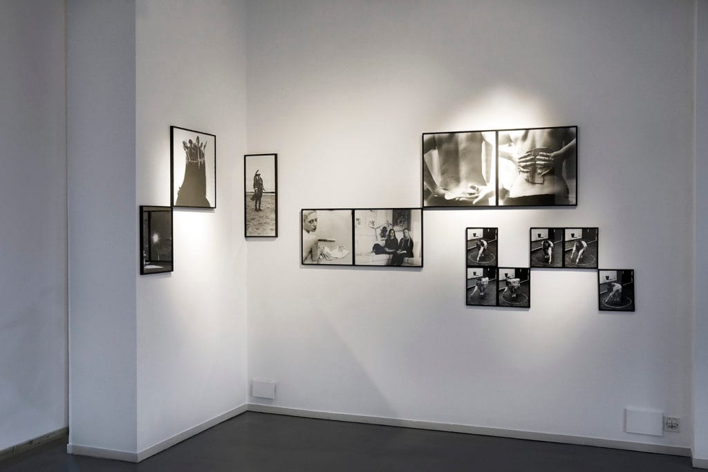 A display of black and white framed images of women in Emily Ryalls: Divine Archives