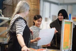 A family screen printing together