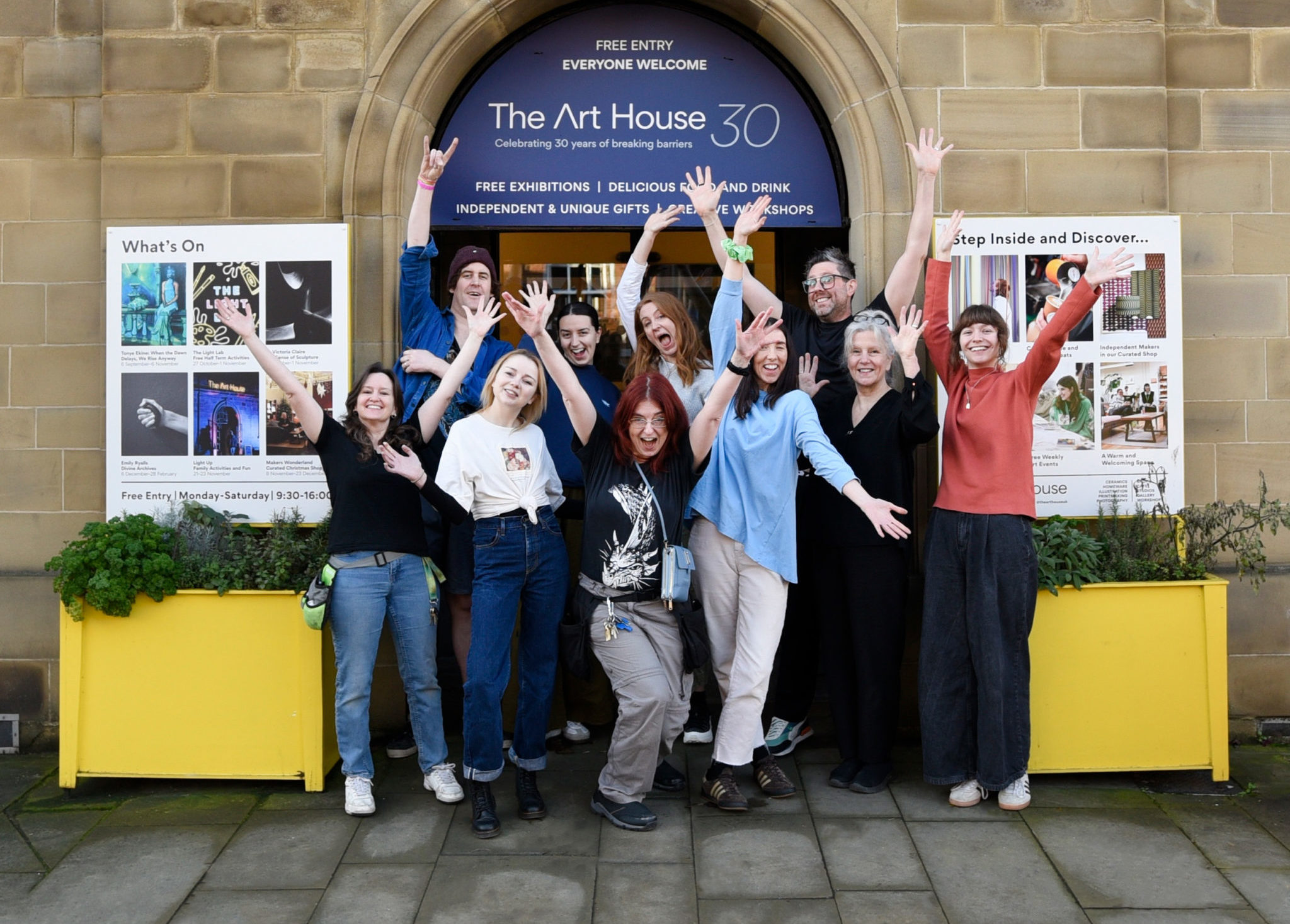 A team photograph of the staff at The Art House stood outside the building.