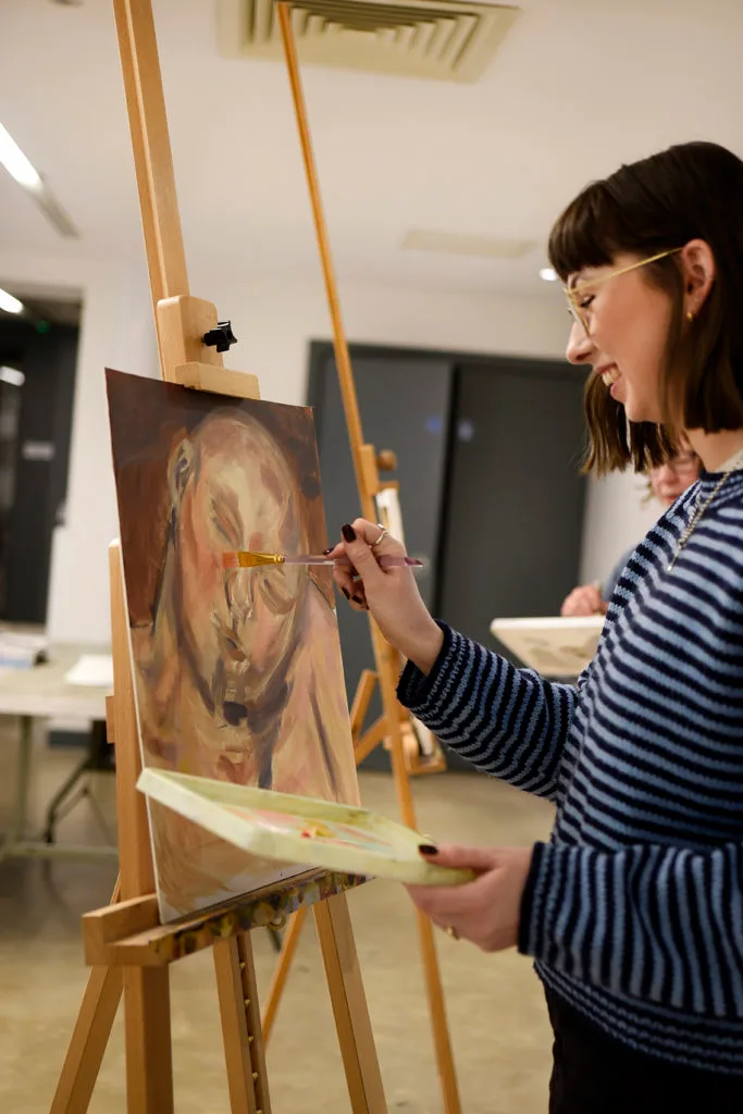 A person stood at an easel painting