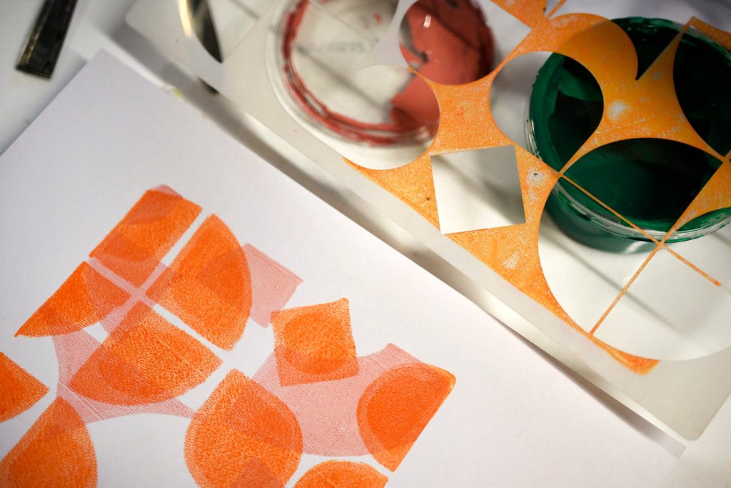 Close up example of a geometric pink and orange Gelli print