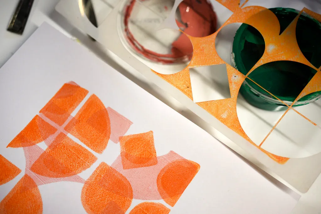 Close up example of a geometric pink and orange Gelli print