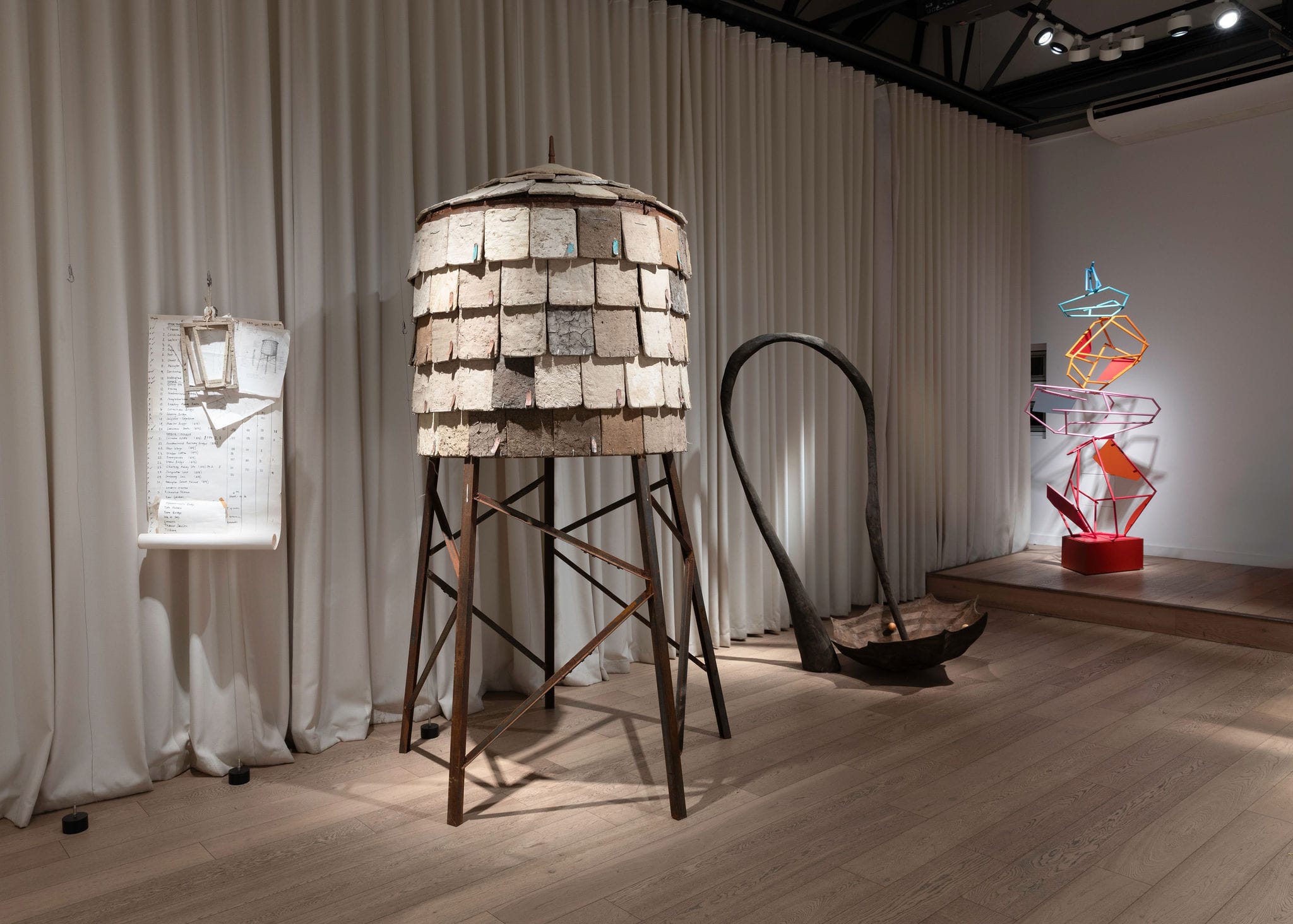 A gallery space filled with contemporary sculptures.